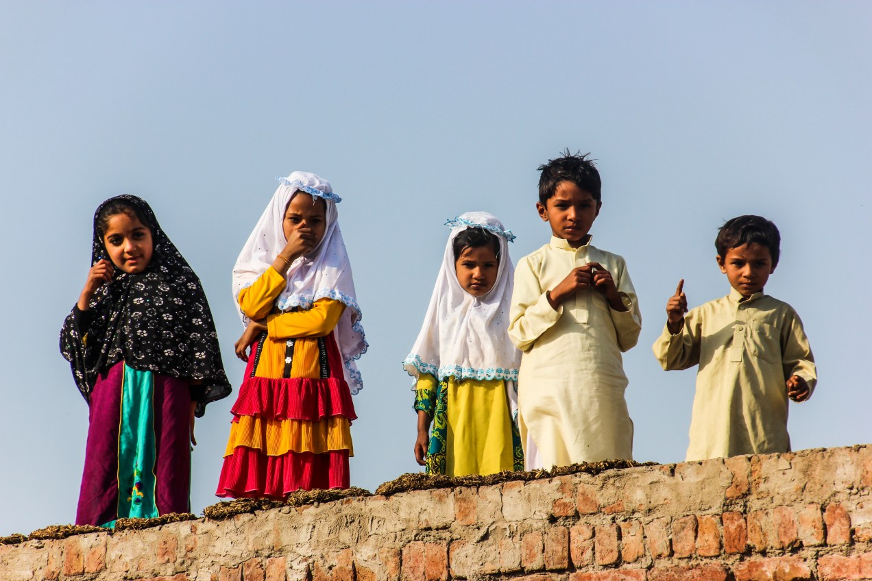 Curious kids on a rooftop.
