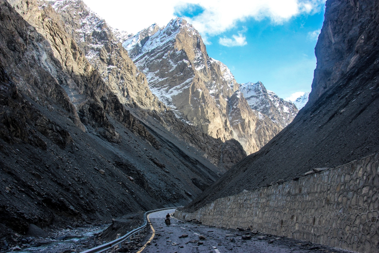 Hugo dodging some rocks with the massive snowy peaks looming above him.